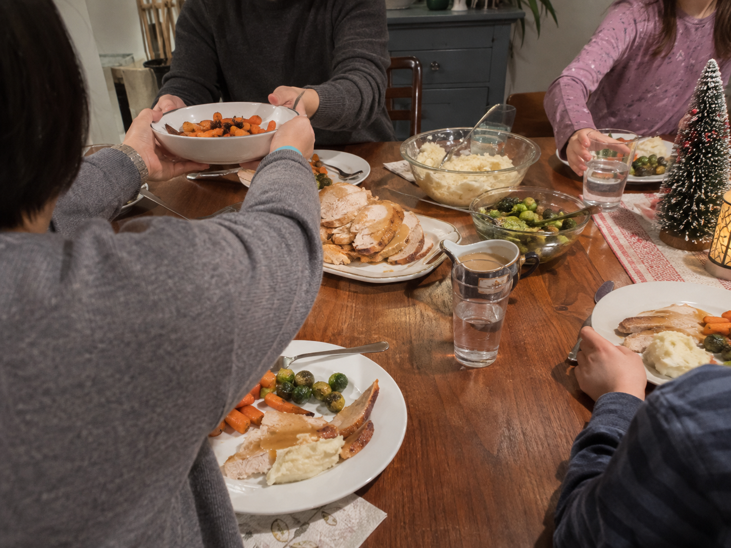 People sharing a turkey dinner at a table