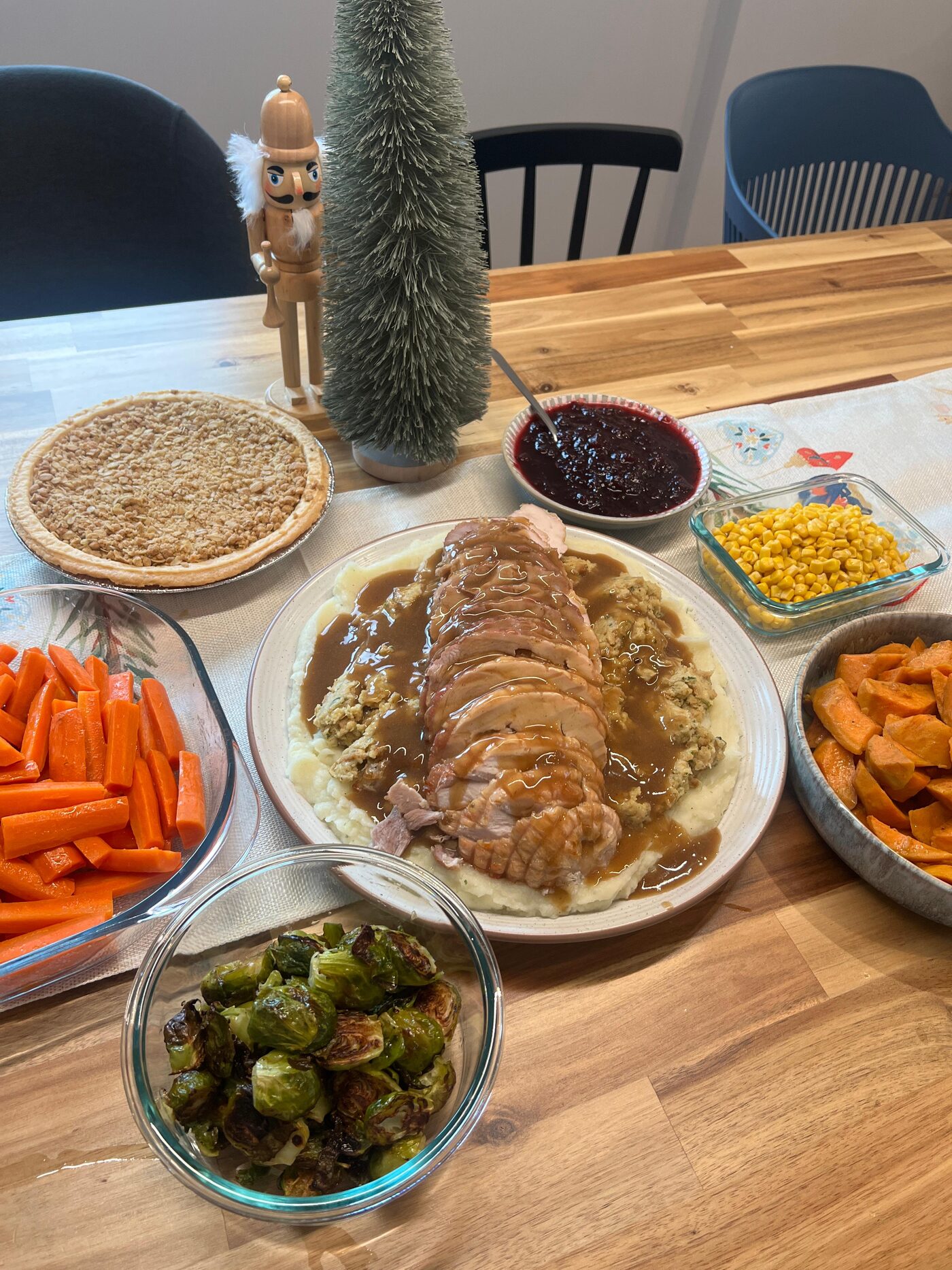 A sliced turkey dinner with side dishes on a table